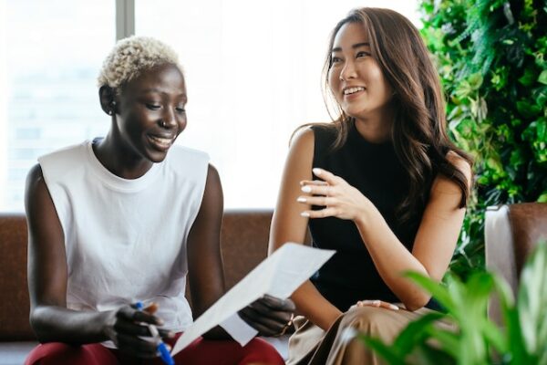 Two women laughing and talking