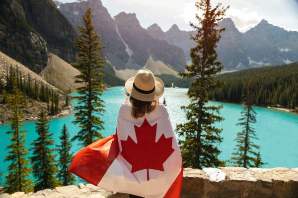 A woman draped in a flag of Canada.