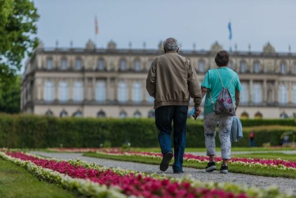An older couple is walking.