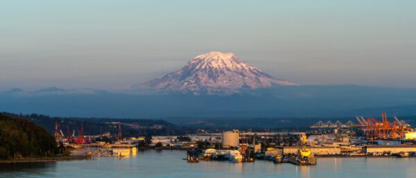 Mountaintop covered in snow overlooking a port