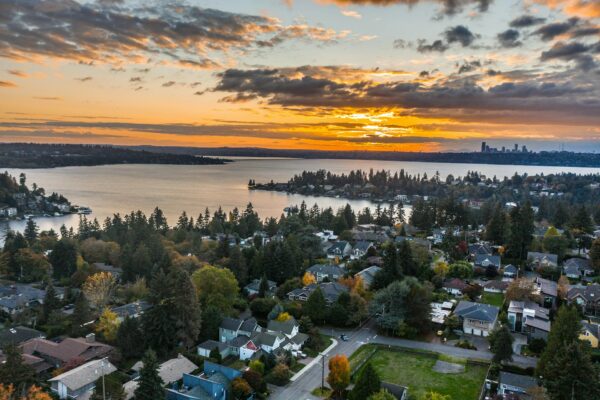 Suburban neighborhood and city line in a sunset over water