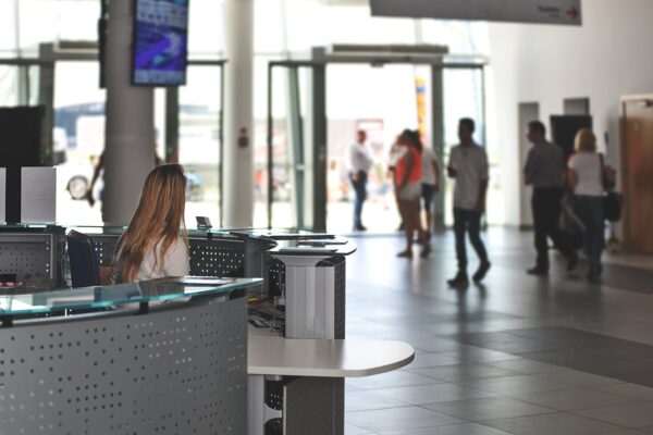 White seating behind the counter under a television.