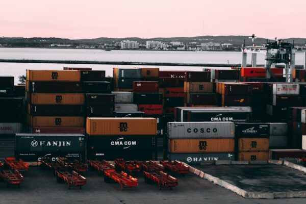 Assorted colored cargo containers near a body of water.